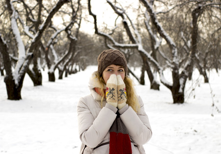 Young beautiful girl close up in winter park enjoys snow fellの写真素材
