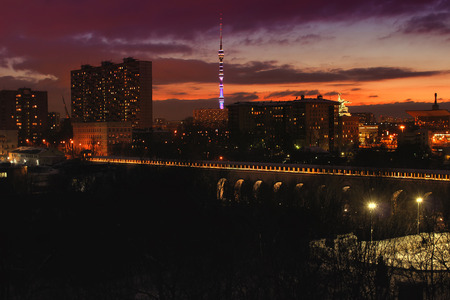 Night landscape of bridge aqueduct on the backround of Worker and collective farmer with the Ostankino tower at sunset. Moscow, Russiaの写真素材