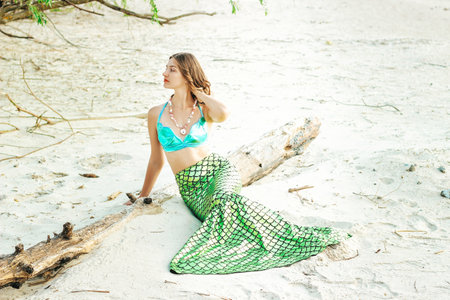 Young beautiful mermaid woman close up standing on the sea cost. Cosplay mermaidの写真素材