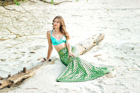 Young beautiful mermaid woman close up standing on the sea cost. Cosplay mermaidの写真素材