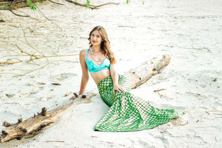 Young beautiful mermaid woman close up standing on the sea cost. Cosplay mermaidの写真素材
