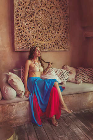 Beautiful lady in the dancing costume close up on the eastern architecture background. Mata Hari cosplay.の写真素材