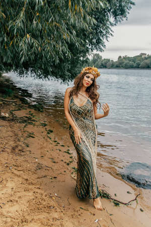 Young beautiful mermaid woman close up is standing in the seawater. Cosplay mermaidの写真素材