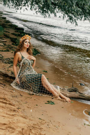 Young beautiful mermaid woman close up is standing in the seawater. Cosplay mermaidの写真素材