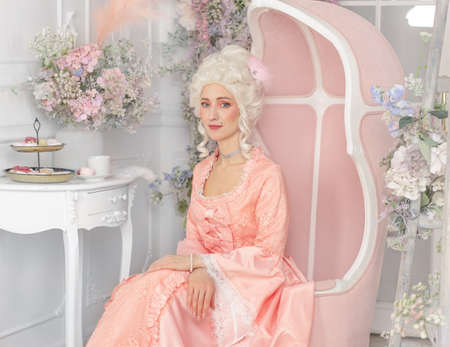 Young pretty woman closeup in pink royal dress. Marie Antoinette cosplayの写真素材