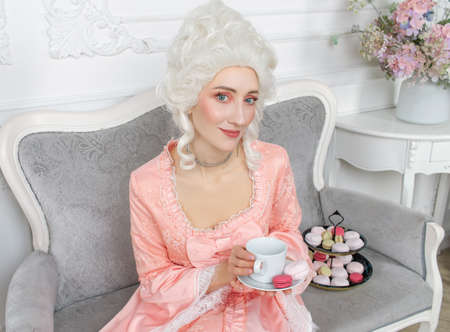 Young pretty woman closeup in pink royal dress. Marie Antoinette cosplayの写真素材