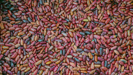 Multicolored beans. Background, many colorful dry beans, top view. Whole grain. Healthy protein food. Organic farm products.の写真素材
