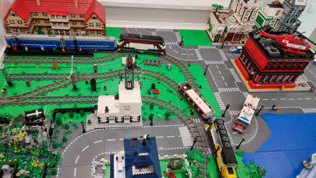 Minsk, Belarus- Ð°Ð¿ÑÐµÐ»Ñ, 22, 2021. Train station, Lego train rides on toy rails. Lego City. Railroad tracks and buildings. The exhibits are created from Lego bricks. View from above.のeditorial素材