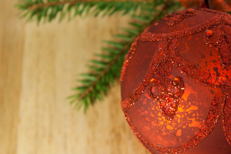 Red Christmas bauble and Spruce Tree Branches on Woodの写真素材