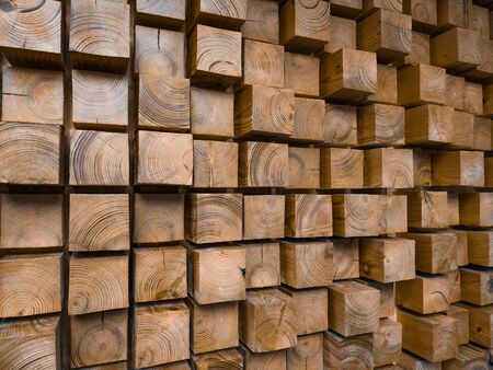 Wall made of wooden blocks protruding over the wallの写真素材