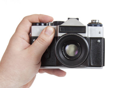 old camera in his hand on a white background