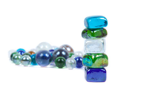 five stones are teetering on the background of round stonesの写真素材