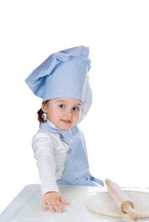 Little girl dressed as a cook posing with pizza doughの写真素材