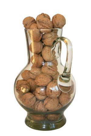 Handful of walnuts in a glass decanter on a white backgroundの写真素材