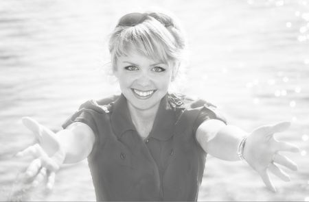 Beautiful blonde in a red dress on a sea resortの写真素材