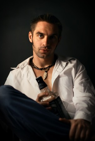 young man in a white shirt on a black backgroundの写真素材