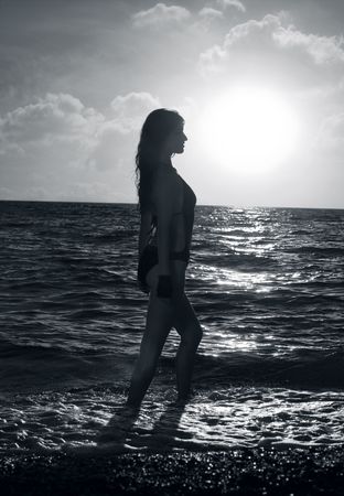 Series. The young beautiful girl walks on a beachの写真素材