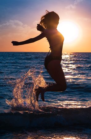 Series. The young beautiful girl walks on a beachの写真素材