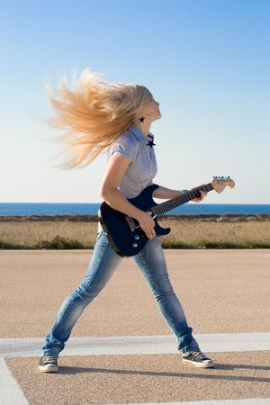Series. The beautiful blonde with a guitarの写真素材