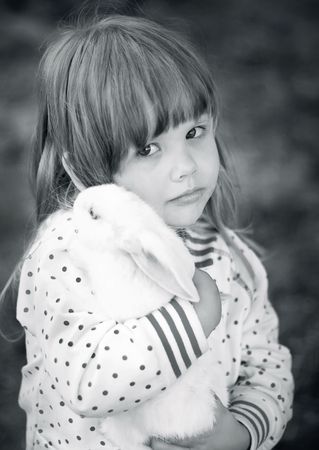 Series. girl plays with a small rabbitの写真素材