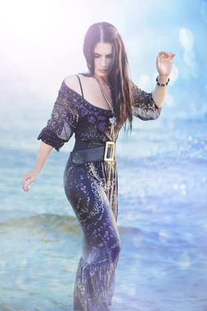 A series. A portrait of the young beautiful brunette in the seaの写真素材