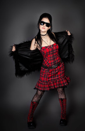 Series. Fashion style photo of young woman in studio  in red dress