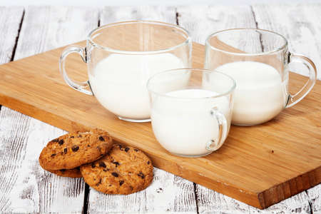 Three milk cups and cookiesの写真素材
