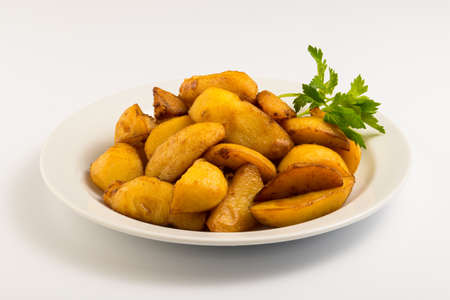 fried potatoes on a white plateの写真素材