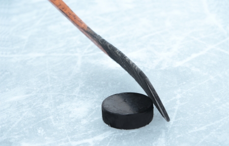 ice hockey stick and puck on iceの写真素材