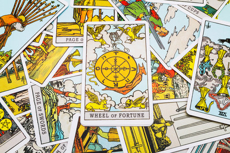 Tarot cards Tarot, the wheel of fortune card in the foreground.