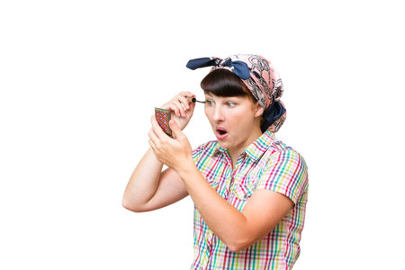 Housewife in a cloth dye eyelashes on white background isolated.の写真素材