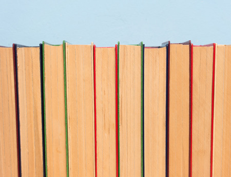 Books on a wooden shelf on a blue backgroundの写真素材