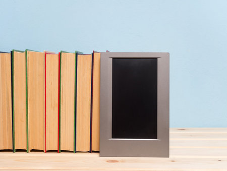 Books on a wooden shelf on a blue backgroundの写真素材
