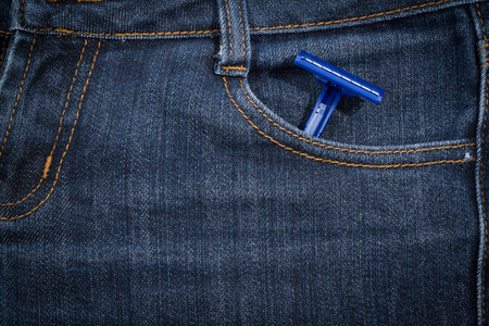 Blue disposable razor in his pocket jeans. Texture, background.の写真素材