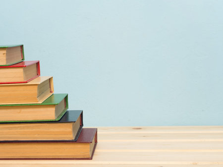 Books on a wooden shelf on a blue backgroundの写真素材