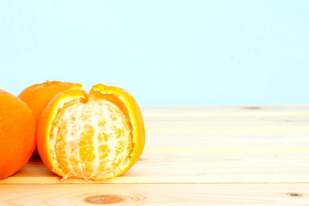 Mandarin on wooden table on blue background.の写真素材