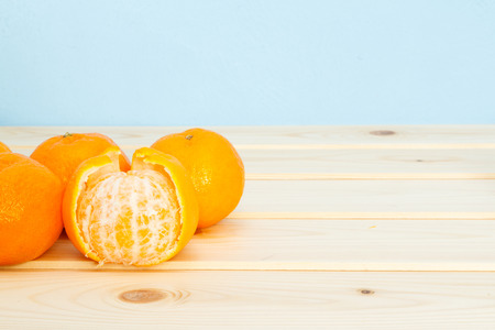 Mandarin on wooden table on blue background.の写真素材