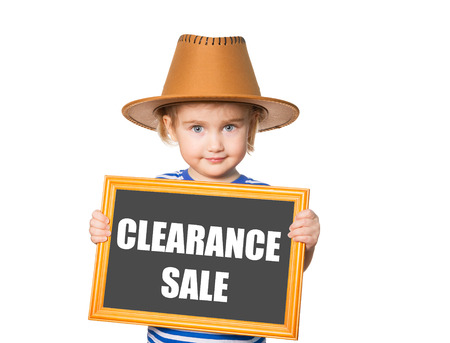 Little Funny girl in striped shirt with blackboard. Text  clearance sale.  Isolated on white backgroundの写真素材