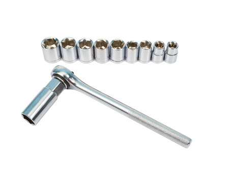 Ratchet and a set of interchangeable heads for chrome socket wrench. Isolated on white background.