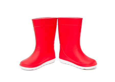 Red  rainboots isolated on white background. Rubber boots for kids.の写真素材