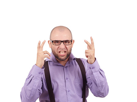 Angry bald man in glasses. Bald businessman in a shirt with suspenders.