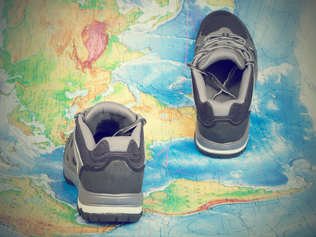 Walking trekking shoes on the world map.Travel and tourism.の写真素材