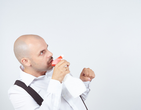 bald male cleaning worker spraying liquid detergent in front of him,の写真素材