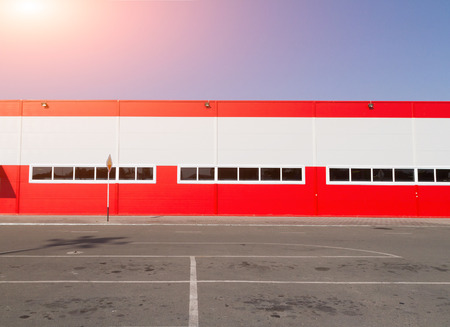 On the facade of a large industrial building made of aluminum panels red.の写真素材