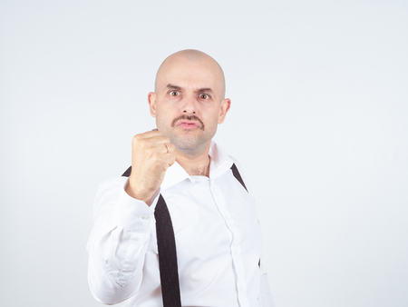 Man fist raised menacing threat. emotions and people concept. isolatedの写真素材