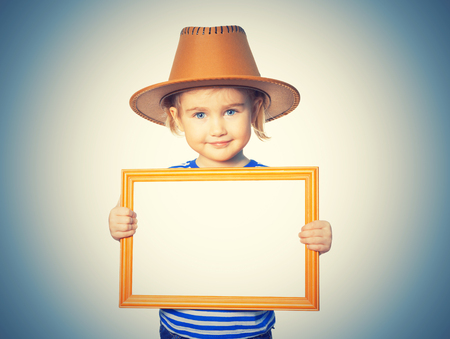 Little Funny girl in striped shirt and hat with blackboard. Isolated on white backgroundの写真素材