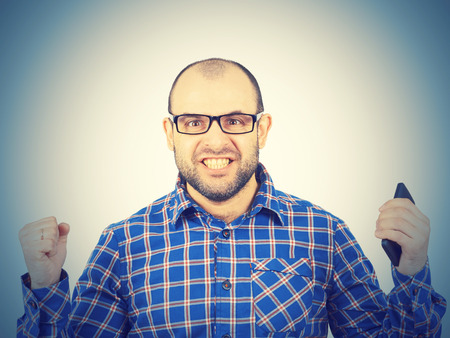 Angry bald man in glasses.  Isolated on a white background.の写真素材
