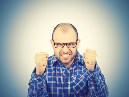 Angry bald man in glasses.  Isolated on a white background.の写真素材