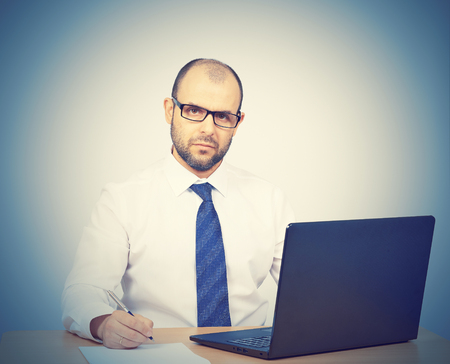Business man working at a computer.Isolated on white backgroundの写真素材