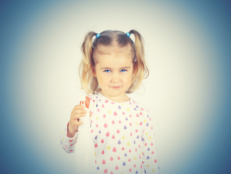 Little girl holding a watering spray bottle. sprayer triggerの写真素材